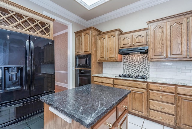 kitchen with black appliances, light tile patterned floors, ornamental molding, and under cabinet range hood