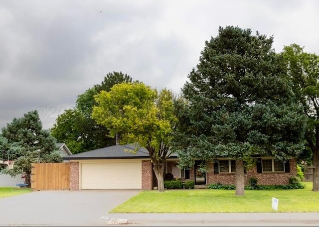 110 Dallam Ave, Dumas, TX 79029 - view of front of property featuring a garage, driveway, and brick siding