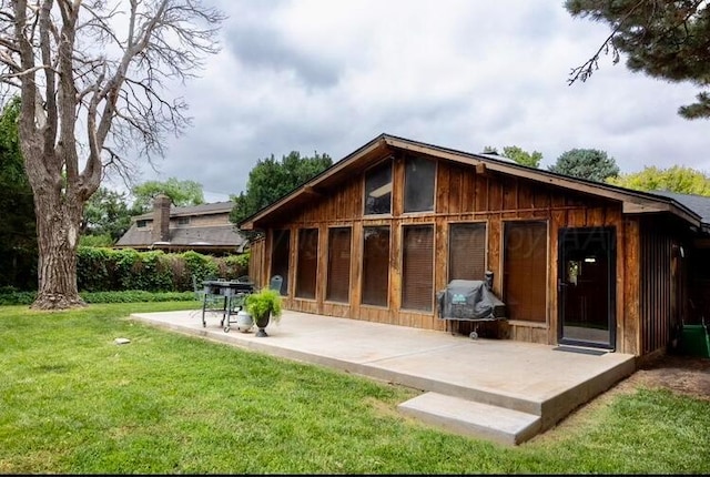 110 Dallam Ave, Dumas, TX 79029 - rear view of house with a patio area and a yard