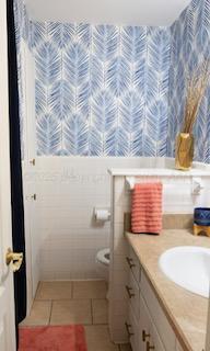 110 Dallam Ave, Dumas, TX 79029 - bathroom featuring vanity, toilet, and tile patterned floors