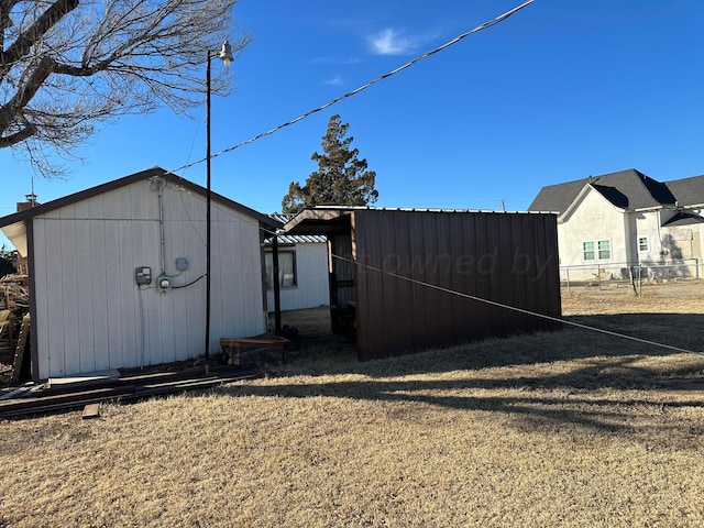 exterior space featuring a storage shed and a lawn