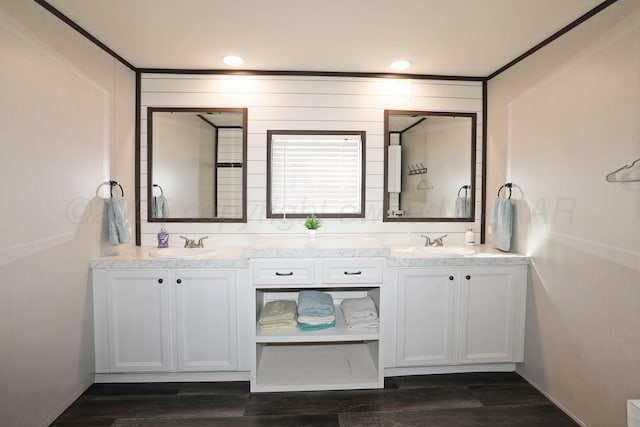 707 Trice St, Claude, TX 79019 - bathroom with a sink, ornamental molding, double vanity, and wood finished floors