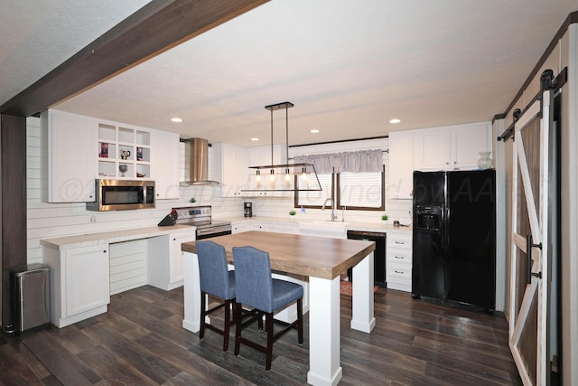 707 Trice St, Claude, TX 79019 - kitchen featuring wall chimney range hood, white cabinetry, butcher block counters, a barn door, and black appliances