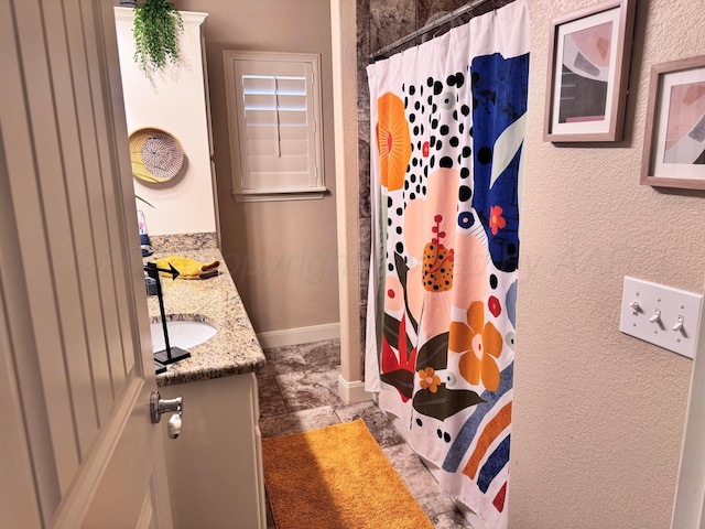 bathroom with vanity and curtained shower