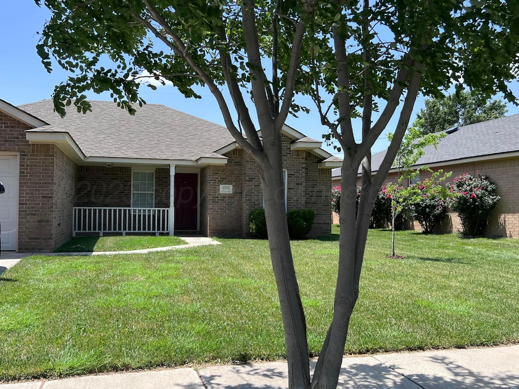 4016 S Williams St, Amarillo, TX 79118 - ranch-style house featuring brick siding, a front yard, and a porch