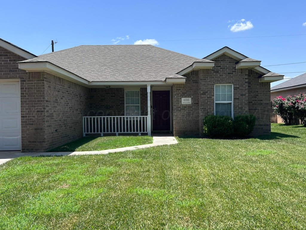 4016 S Williams St, Amarillo, TX 79118 - view of front of home featuring a porch, a front yard, brick siding, and a shingled roof