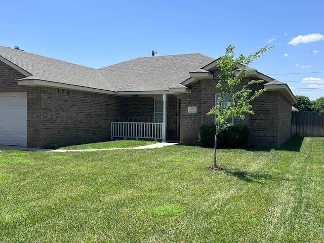 4016 S Williams St, Amarillo, TX 79118 - view of front of home with brick siding, a front lawn, an attached garage, and a shingled roof