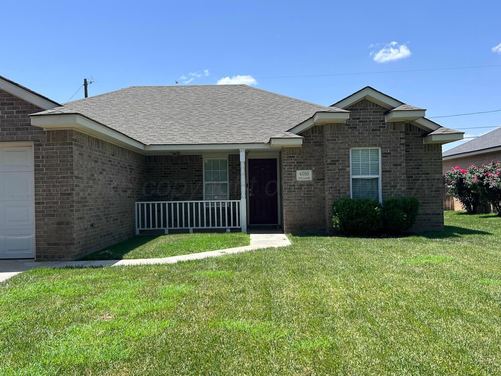 4016 S Williams St, Amarillo, TX 79118 - ranch-style home featuring a porch, brick siding, a front yard, an attached garage, and a shingled roof