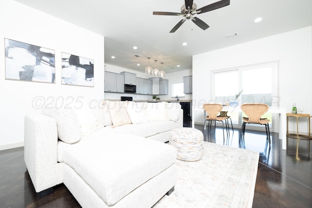 4108 Inez Way, Amarillo, TX 79124 - living room featuring recessed lighting, ceiling fan, baseboards, concrete floors, and a chandelier