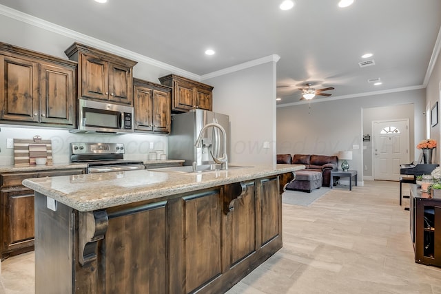 5013 Gloster St, Amarillo, TX 79118 - kitchen with stainless steel appliances, ceiling fan, recessed lighting, a center island with sink, and light stone counters