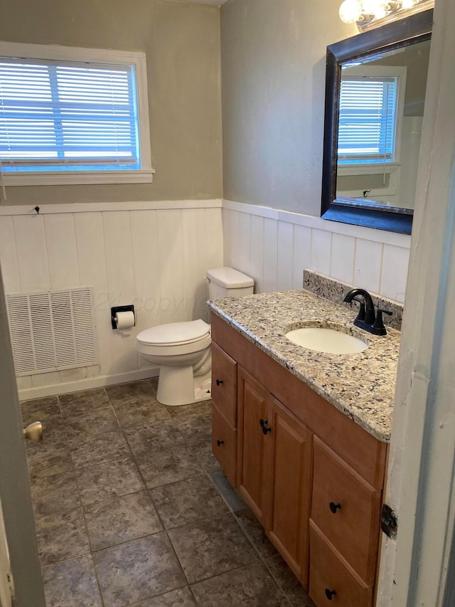 3706 Lenwood Dr, Amarillo, TX 79109 - half bath featuring vanity, wainscoting, and toilet
