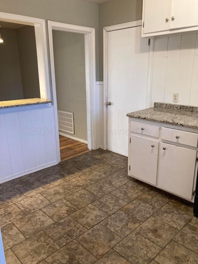 3706 Lenwood Dr, Amarillo, TX 79109 - kitchen featuring white cabinets, light stone counters, and stone finish flooring