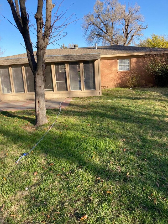 3706 Lenwood Dr, Amarillo, TX 79109 - back of property with a sunroom and a yard
