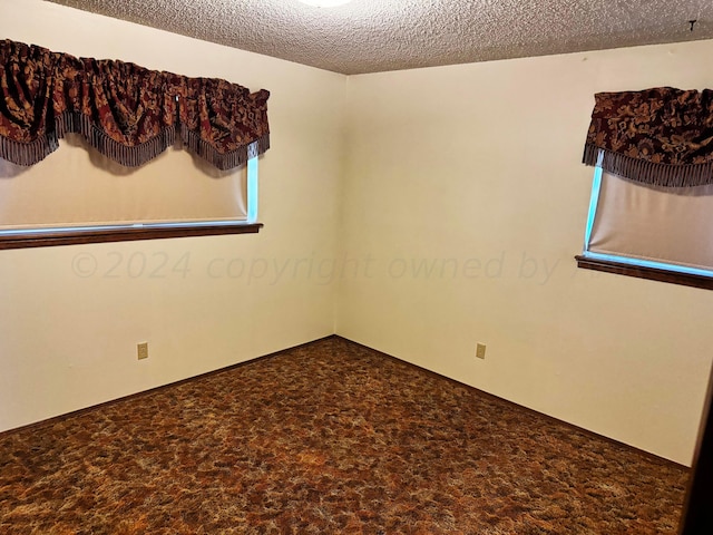 106 Middle St, Balko, OK 73931 - carpeted spare room featuring a textured ceiling