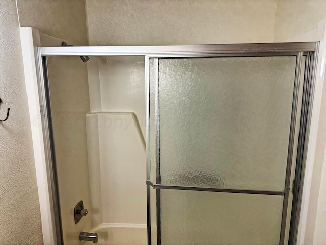 106 Middle St, Balko, OK 73931 - bathroom featuring combined bath / shower with glass door