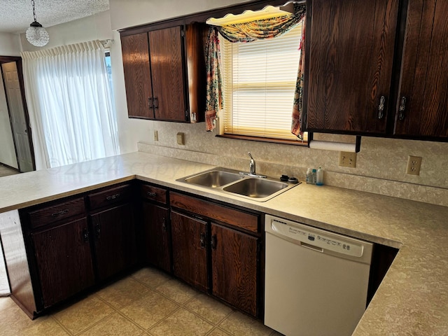 106 Middle St, Balko, OK 73931 - kitchen featuring sink, a textured ceiling, decorative light fixtures, dark brown cabinets, and dishwasher