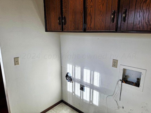 106 Middle St, Balko, OK 73931 - clothes washing area featuring washer hookup and cabinets