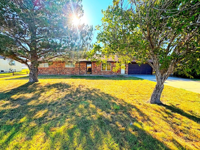 view of front of home with a garage and a front yard