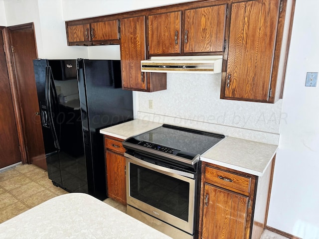 106 Middle St, Balko, OK 73931 - kitchen featuring black fridge and stainless steel range with electric stovetop