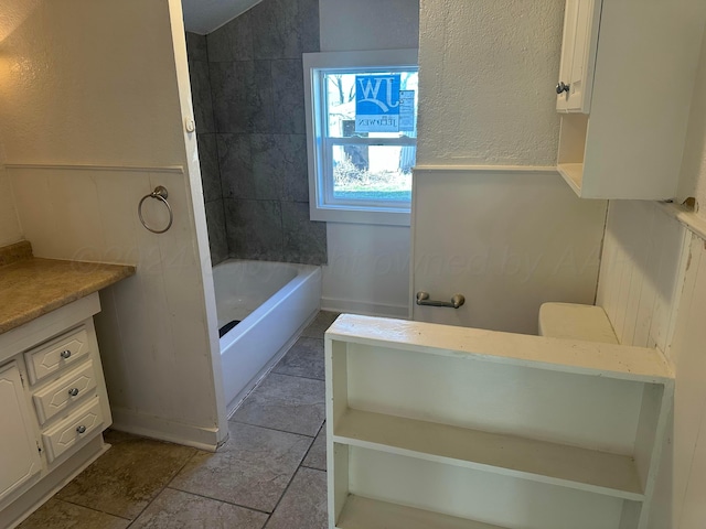 bathroom with vanity, lofted ceiling, and tiled shower / bath combo