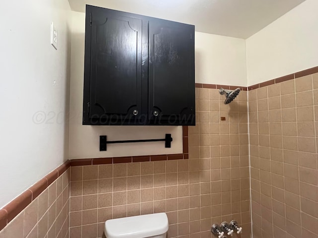 bathroom with tile walls and toilet