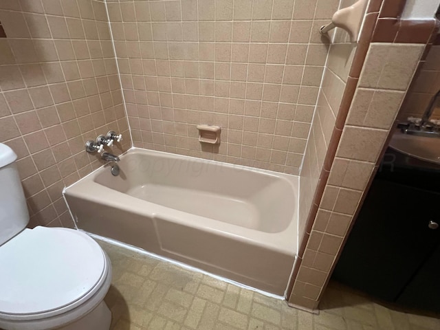 full bathroom featuring toilet, tiled shower / bath combo, and sink