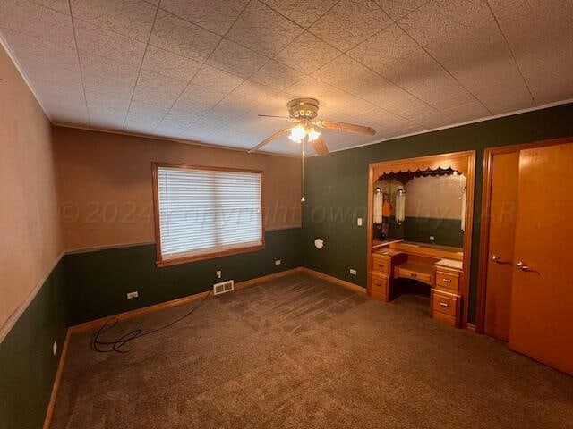 unfurnished bedroom with carpet flooring and ceiling fan