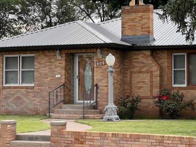 property entrance with a yard