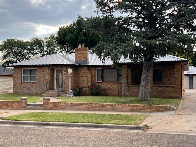 single story home with a garage and a front yard