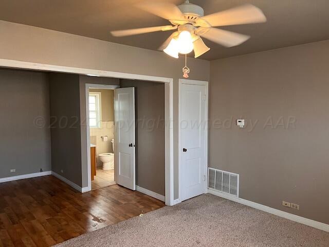 unfurnished bedroom featuring dark hardwood / wood-style flooring, a closet, and ceiling fan