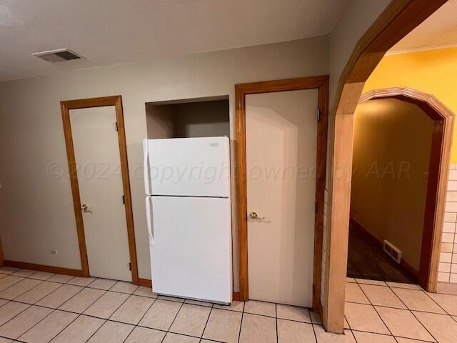 hallway with light tile patterned floors