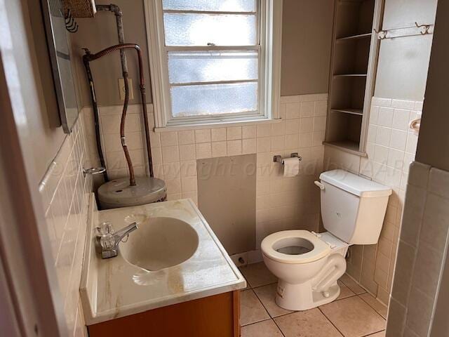 bathroom featuring tile walls, tile patterned flooring, vanity, and toilet