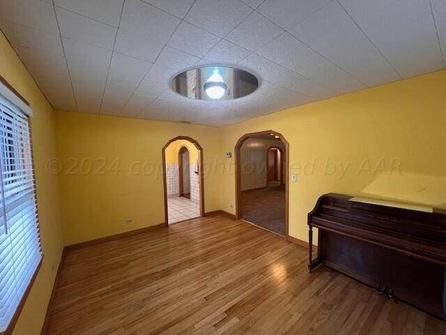 spare room with wood-type flooring