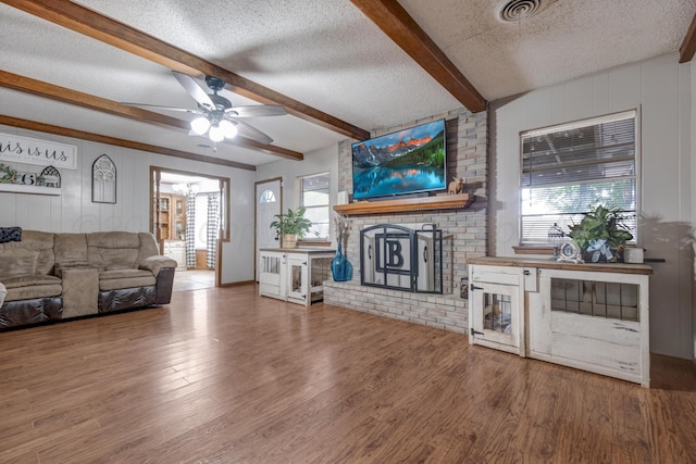 3409 Harmony St, Amarillo, TX 79109 - living area with a textured ceiling, a ceiling fan, wood finished floors, and beamed ceiling