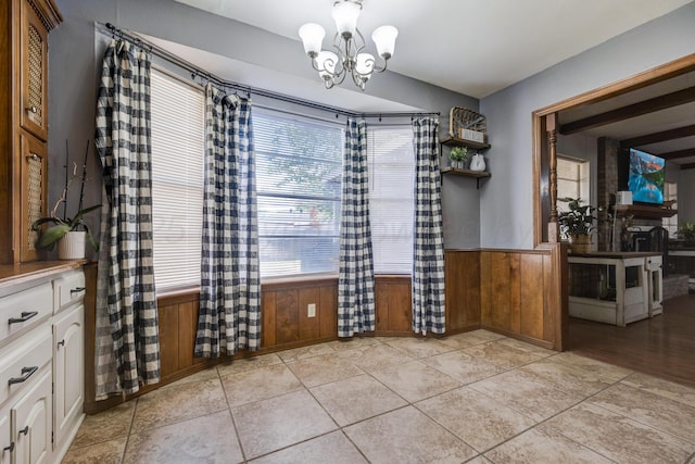 3409 Harmony St, Amarillo, TX 79109 - unfurnished dining area featuring a chandelier, plenty of natural light, wainscoting, and wooden walls