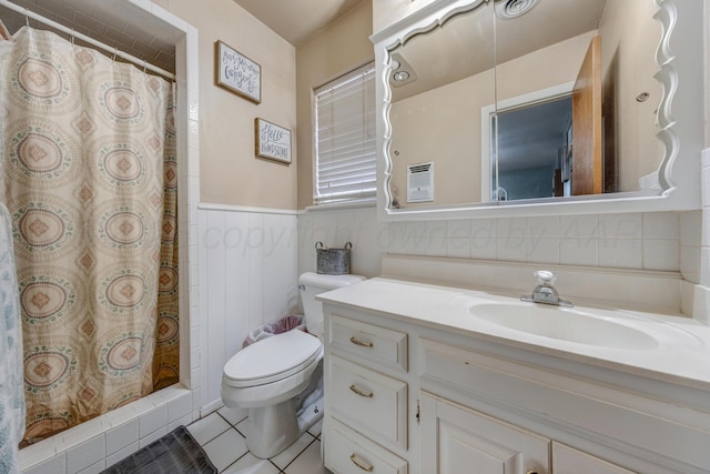 3409 Harmony St, Amarillo, TX 79109 - bathroom featuring vanity, tile patterned floors, wainscoting, and curtained shower