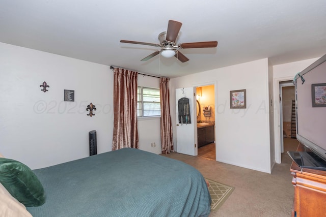 bedroom with carpet flooring, a ceiling fan, and connected bathroom