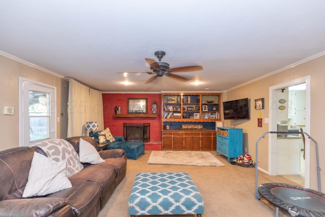 living area with carpet floors, a ceiling fan, ornamental molding, and a brick fireplace