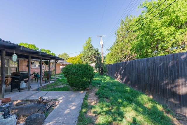 fenced backyard with a patio area