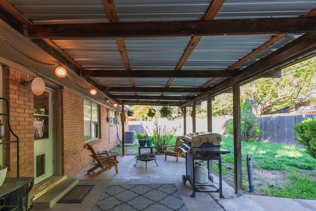view of patio featuring a fire pit, area for grilling, a fenced backyard, and central AC