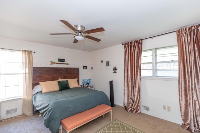 carpeted bedroom with a ceiling fan and baseboards
