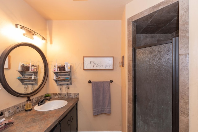 bathroom with a stall shower and vanity