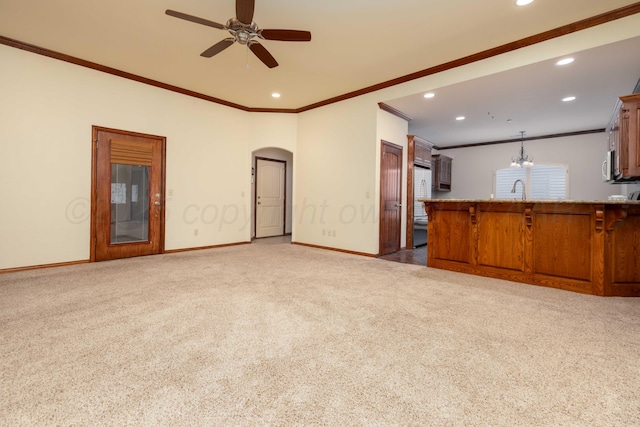 8102 Little Rock Dr, Amarillo, TX 79118 - unfurnished living room featuring crown molding, carpet floors, recessed lighting, ceiling fan, and arched walkways