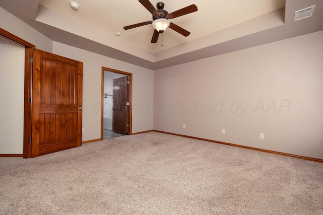 8102 Little Rock Dr, Amarillo, TX 79118 - unfurnished bedroom with a raised ceiling, carpet flooring, connected bathroom, and a ceiling fan