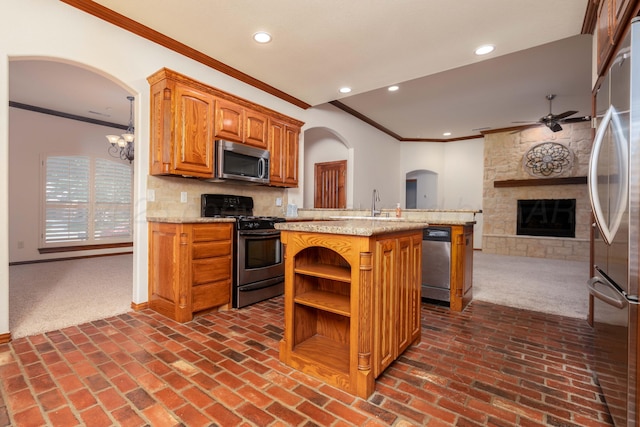 8102 Little Rock Dr, Amarillo, TX 79118 - kitchen featuring stainless steel appliances, ornamental molding, ceiling fan, open floor plan, and dark carpet