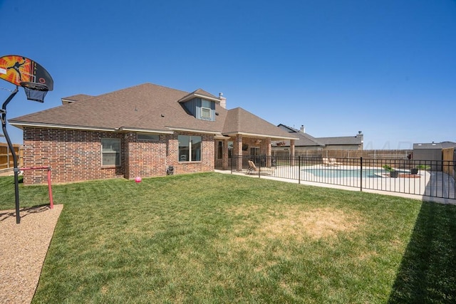32 Kenna Ln, Canyon, TX 79015 - rear view of property with a patio area, a lawn, fence, brick siding, and a fenced in pool