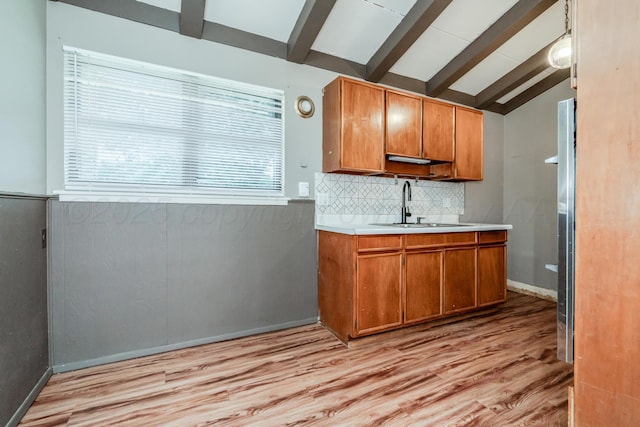 3110 S Apache St, Amarillo, TX 79103 - kitchen with light countertops, backsplash, light wood finished floors, and brown cabinets