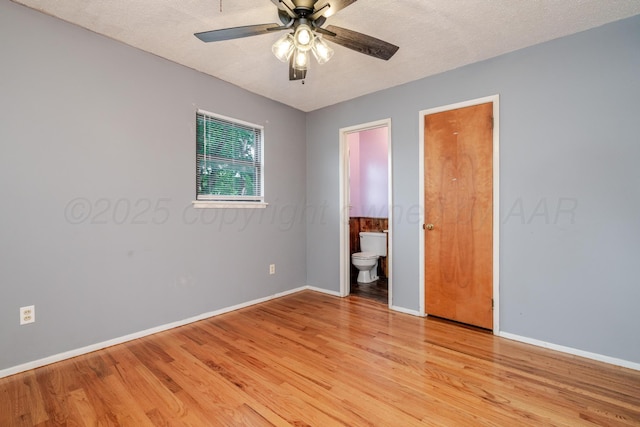 3110 S Apache St, Amarillo, TX 79103 - unfurnished bedroom with light wood finished floors, connected bathroom, a textured ceiling, and a ceiling fan