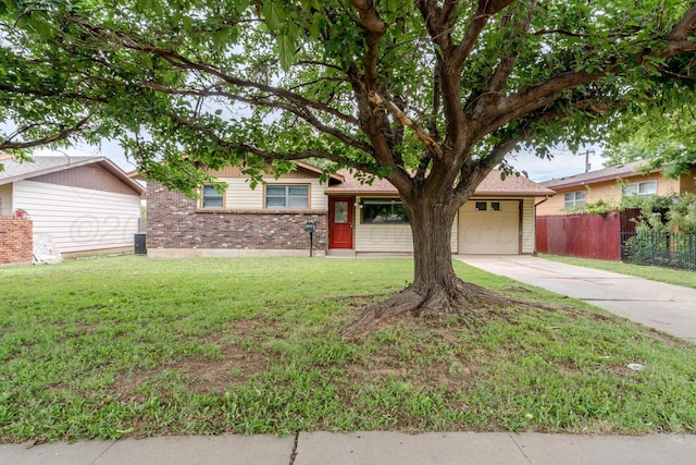 3110 S Apache St, Amarillo, TX 79103 - tri-level home with concrete driveway, an attached garage, and brick siding