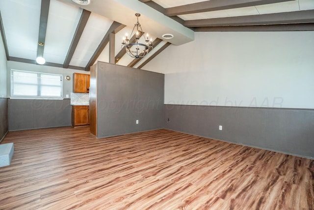 3110 S Apache St, Amarillo, TX 79103 - unfurnished living room with wood finished floors and a chandelier
